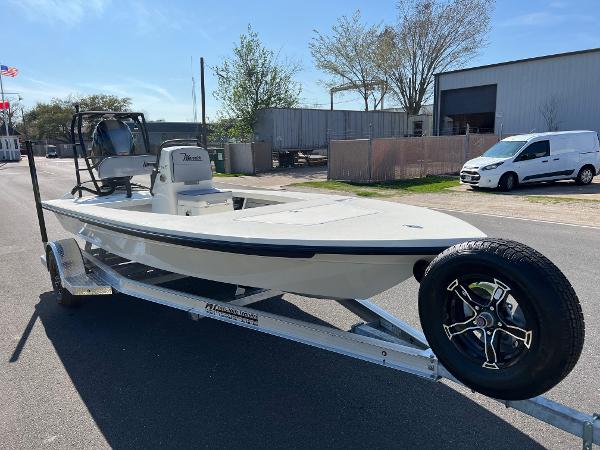 Slide: The Image of 2024 Maverick 18 HPX-V boat on a trailer in an industrial area. - 5