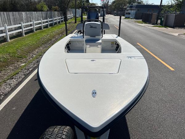 Slide: The Image of 2024 Maverick 18 HPX-V boat on a trailer, parked on a street. - 6