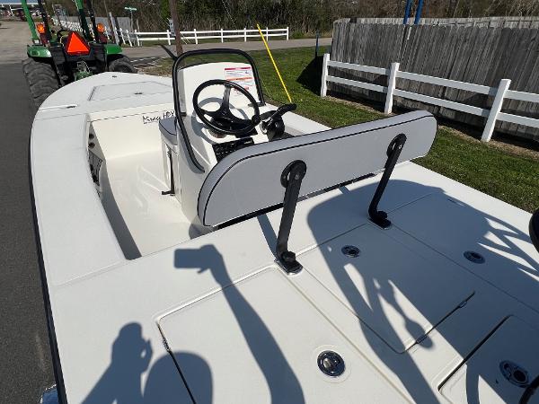 Slide: The Image of 2024 Maverick 18 HPX-V boat with console and seating, parked on a road. - 8