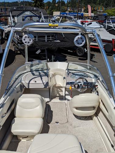 Slide: The Image of 2007 Maxum 1800 SR3 boat interior with seating and steering wheel, docked at a marina. - 10