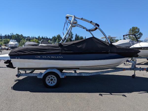 Slide: The Image of 2007 Maxum 1800 SR3 boat on trailer, covered and parked outdoors. - 2
