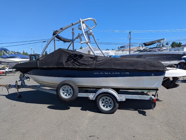 Slide: The Image of 2007 Maxum 1800 SR3 boat on trailer with cover, parked outdoors. - 3