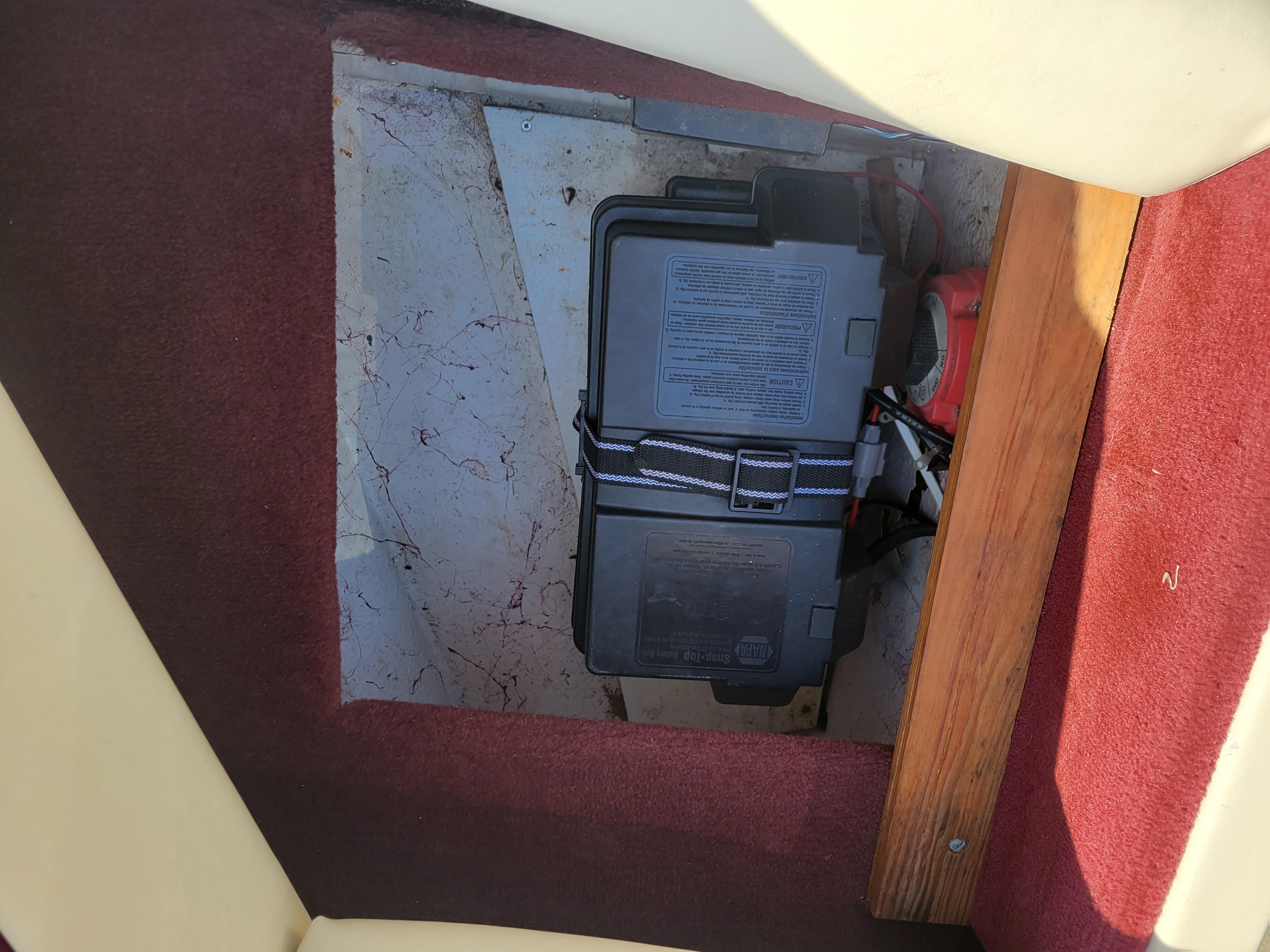 Slide: The Image of Battery compartment of a 1991 Maxum 2100 XC boat with red carpet and wooden trim. - 21