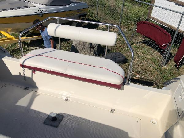 Slide: The Image of 1992 Maxum 2300 SCR boat seat with white and red upholstery, outdoor setting. - 11