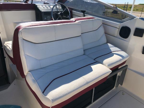 Slide: The Image of 1992 Maxum 2300 SCR boat interior with white and red seating, steering wheel, and dashboard. - 12