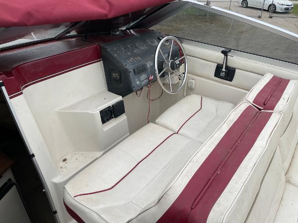 Slide: The Image of 1992 Maxum 2300 SCR boat interior with red and white seating and steering console. - 5