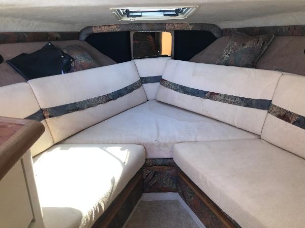 Slide: The Image of 1992 Maxum 2300 SCR cabin interior with beige seating and patterned accents. - 7