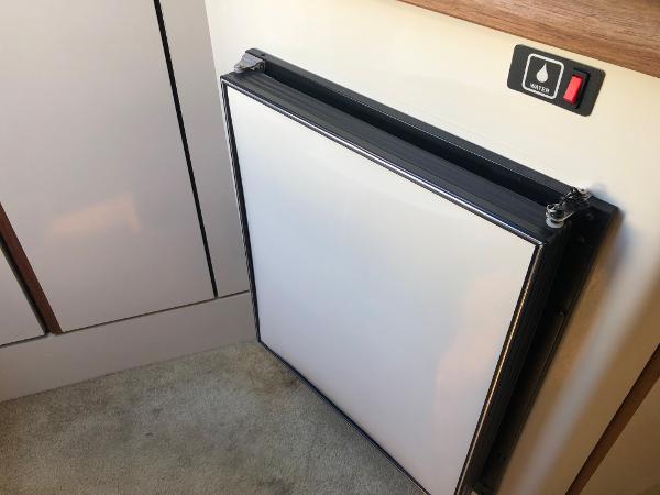 Slide: The Image of 1992 Maxum 2300 SCR interior with a compact refrigerator and control panel. - 8