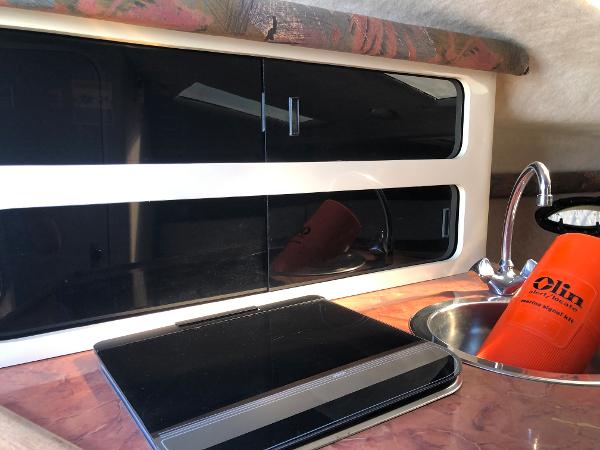 Slide: The Image of Interior of 1992 Maxum 2300 SCR boat with sleek cabinets and compact sink. - 9