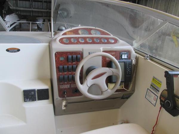 Slide: The Image of Maxum 2400 SCR 2000 boat dashboard with steering wheel and control panel. - 11
