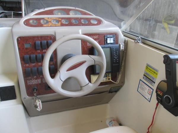 Slide: The Image of Maxum 2400 SCR 2000 boat dashboard with steering wheel and control panel. - 12