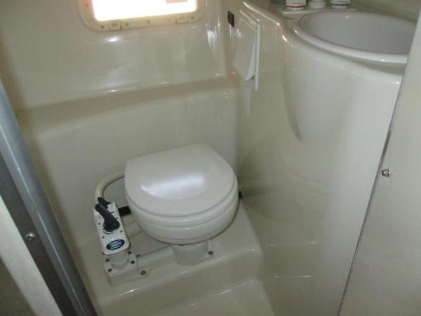 Slide: The Image of Compact bathroom in 2000 Maxum 2400 SCR boat with toilet and sink. - 15