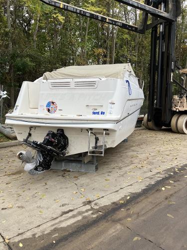 Slide: The Image of 2000 Maxum 2400 SCR boat on a lift, rear view. - 2