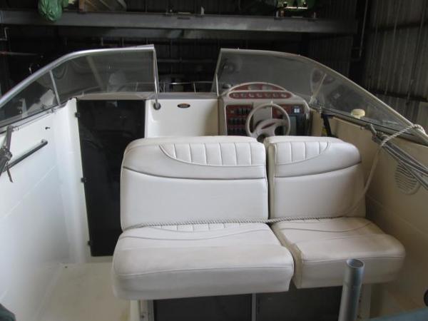 Slide: The Image of 2000 Maxum 2400 SCR boat interior with white seating and dashboard. - 8