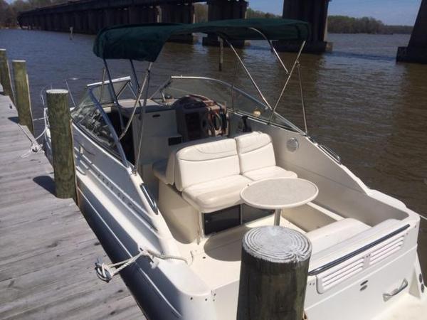 Slide: The Image of 2000 Maxum 2400 SCR boat docked by a wooden pier. - 9