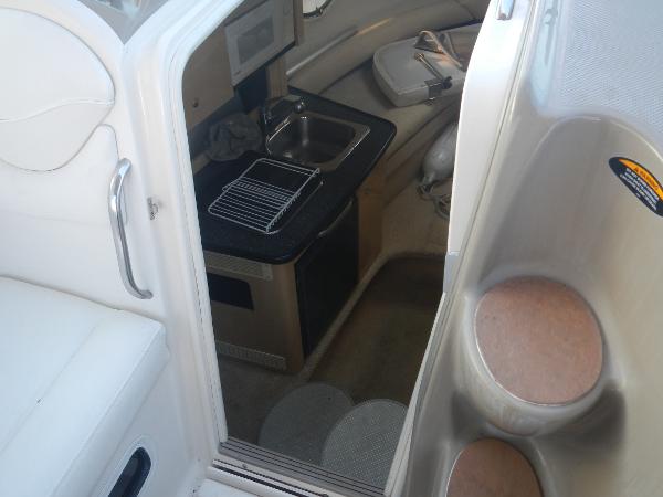 Slide: The Image of Interior view of 2001 Maxum 2500 SCR boat showing kitchenette and seating area. - 11