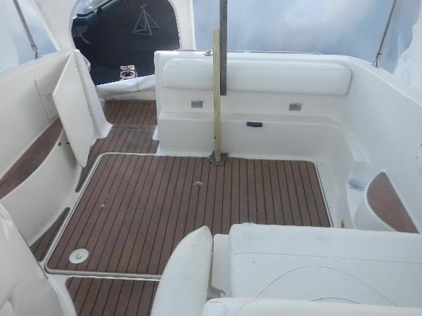 Slide: The Image of 2001 Maxum 2500 SCR boat interior with teak flooring and white seating. - 12