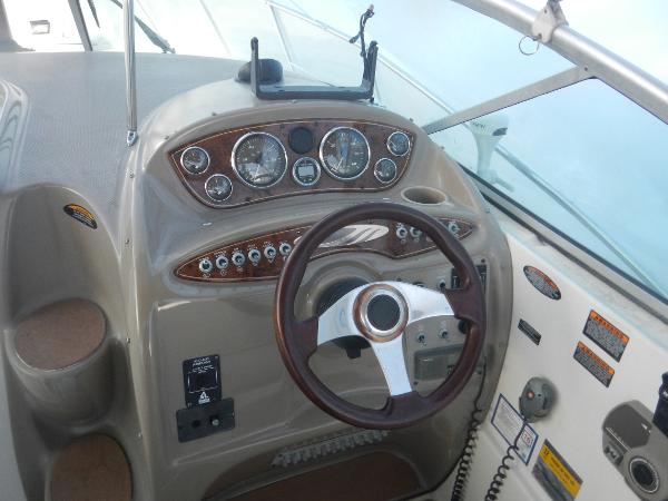 Slide: The Image of 2001 Maxum 2500 SCR boat dashboard with steering wheel and instrument panel. - 16