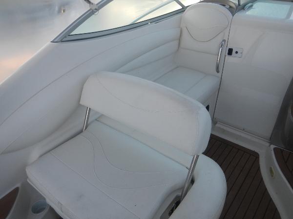 Slide: The Image of 2001 Maxum 2500 SCR boat interior with white seating and wooden flooring. - 18