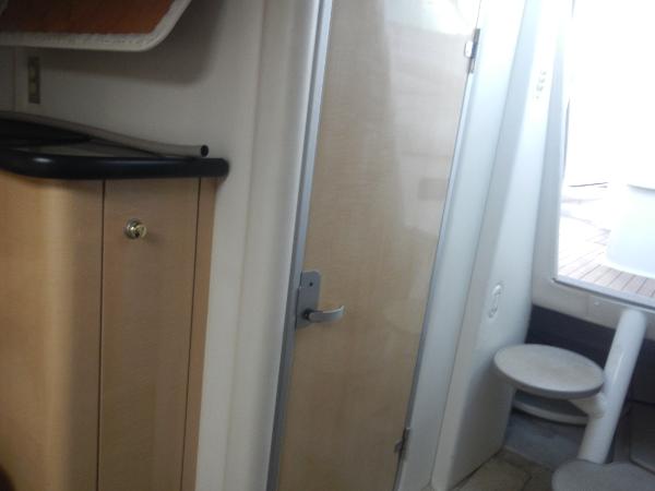 Slide: The Image of Interior of 2001 Maxum 2500 SCR boat showing cabin door and storage cabinet. - 7