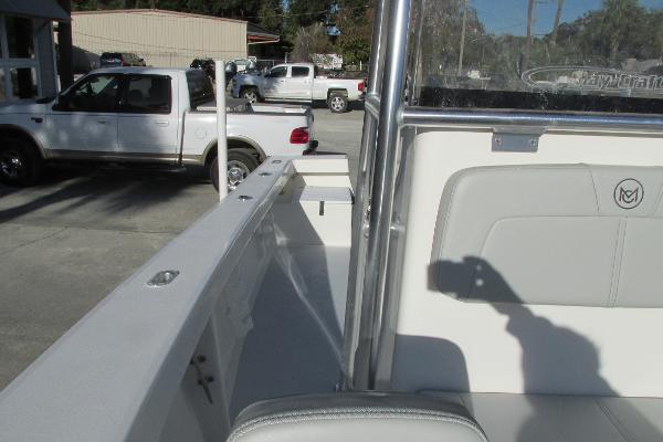 Slide: The Image of 2023 May-Craft 20 Cape Classic boat interior with parked trucks in the background. - 16