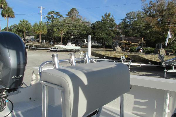 Slide: The Image of 2023 May-Craft 20 Cape Classic boat with 150 HP engine, docked near palm trees. - 8