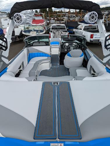 Slide: The Image of 2022 MB B52-21 Classic boat interior with blue and white seating, docked at marina. - 8
