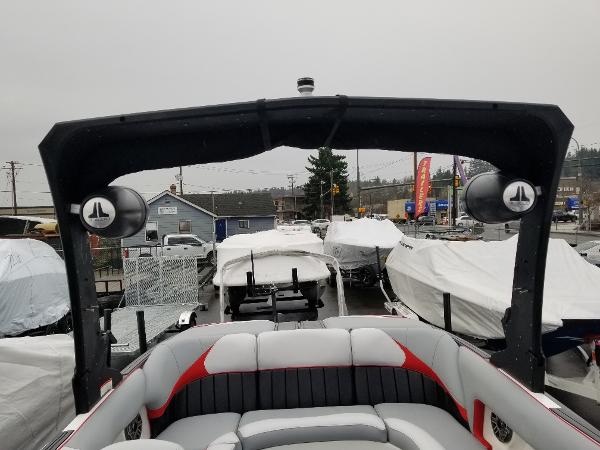 Slide: The Image of 2022 MB B52-23 boat with covered seats and speakers in a marina. - 11