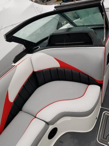 Slide: The Image of 2022 MB B52-23 boat interior with red and gray seating. - 12