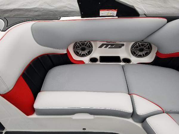 Slide: The Image of 2022 MB B52-23 boat interior with gray and red seating, speakers, and MB logo. - 14