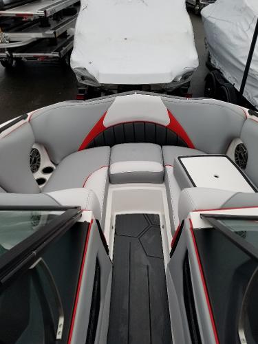 Slide: The Image of 2022 MB B52-23 boat interior with gray and red seating, speakers, and storage. - 16