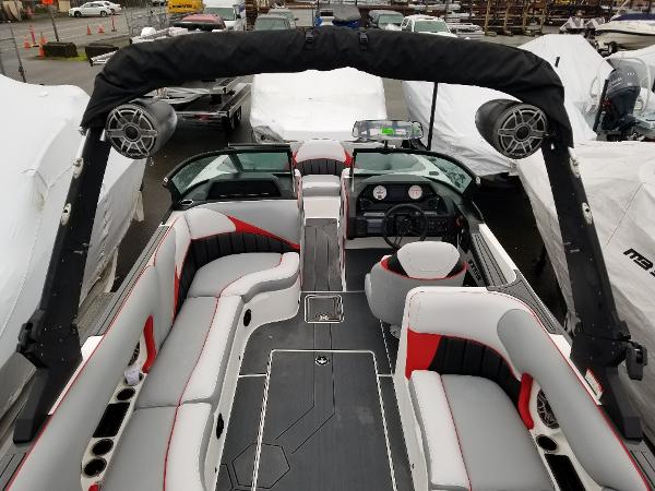 Slide: The Image of 2022 MB B52-23 boat interior with seating, speakers, and dashboard. - 19