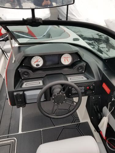 Slide: The Image of 2022 MB B52-23 boat dashboard with steering wheel and gauges. - 8