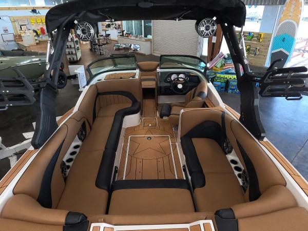 Slide: The Image of 2023 MB B52 Alpha boat interior with tan and black seating, advanced dashboard, and spacious layout. - 11