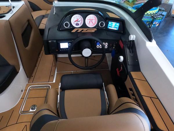 Slide: The Image of 2023 MB B52 Alpha boat cockpit with modern dashboard and brown leather seats. - 16