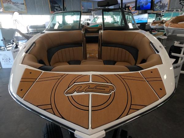 Slide: The Image of 2023 MB B52 Alpha boat with tan and black interior, displayed in a showroom. - 4