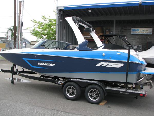 Slide: The Image of 2022 MB F22 Tomcat boat on trailer, blue and white, parked outside. - 0