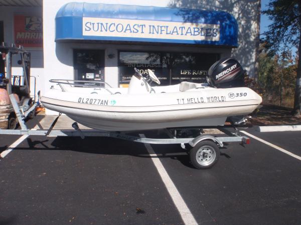 Slide: The Image of 2014 Mercury Amanzi 350 inflatable boat on trailer outside Suncoast Inflatables store. - 0