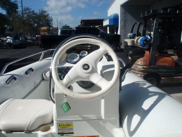 Slide: The Image of 2014 Mercury Amanzi 350 boat steering console and dashboard. - 1