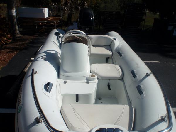 Slide: The Image of 2014 Mercury Amanzi 350 inflatable boat with white seating and console. - 3