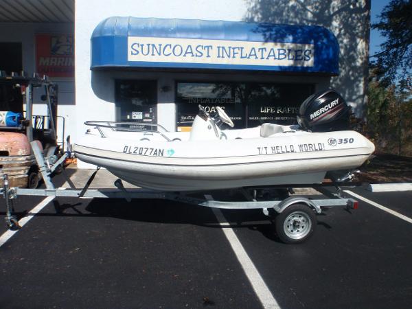 Slide: The Image of 2014 Mercury Amanzi 350 inflatable boat on trailer outside Suncoast Inflatables store. - 4