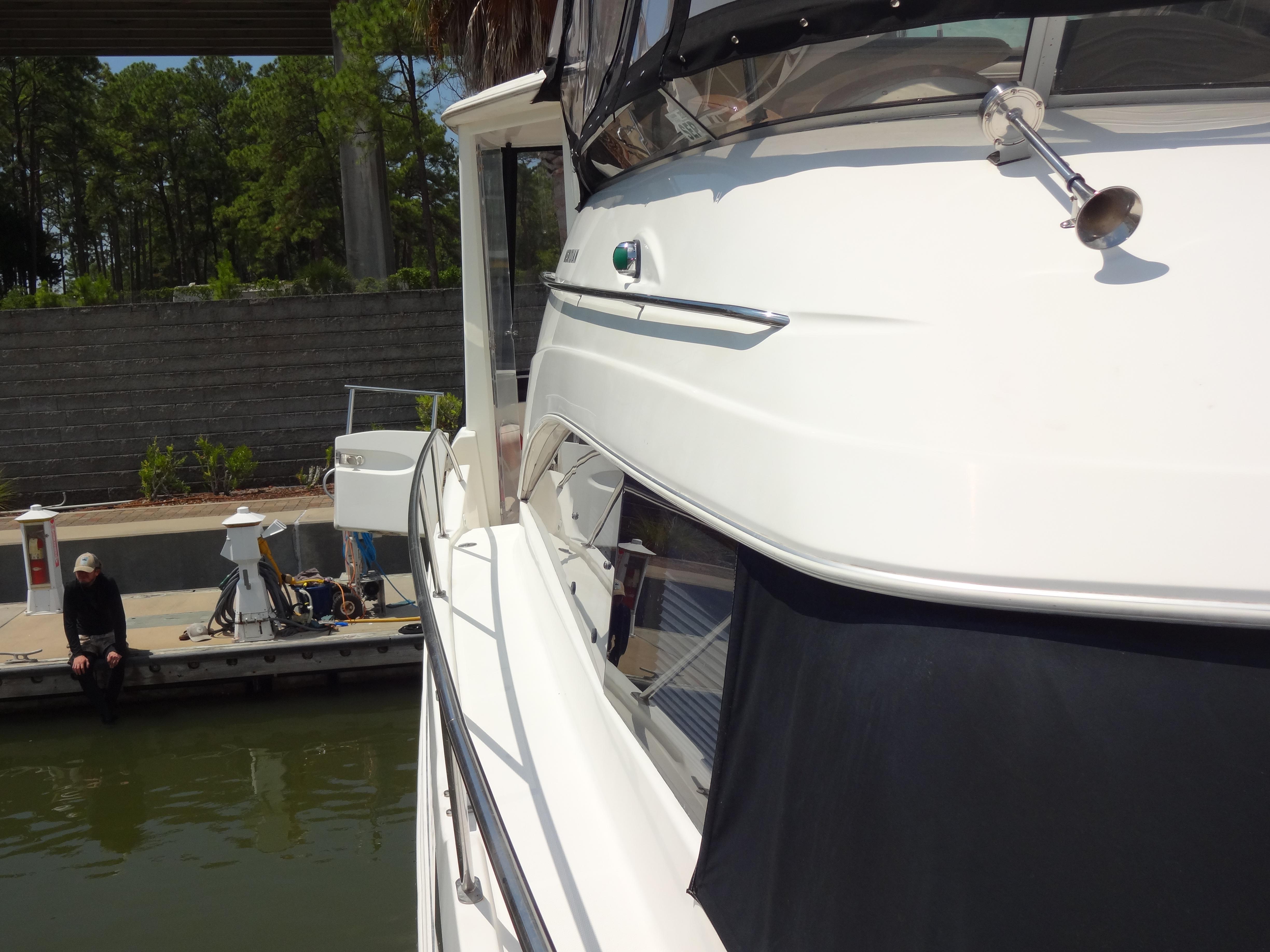 Slide: The Image of 2004 Meridian 408 Motoryacht docked at marina with a person sitting nearby. - 19