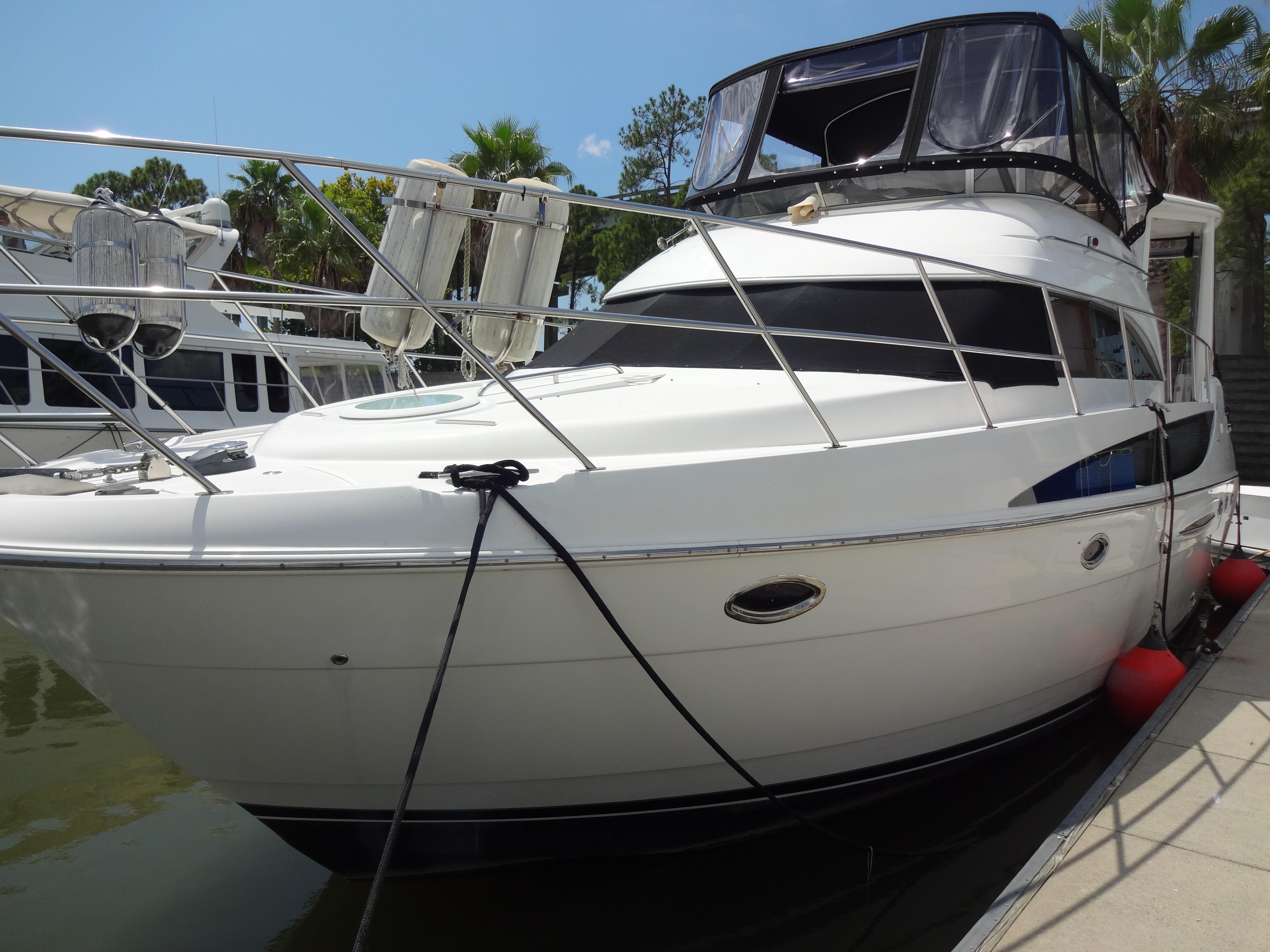 Slide: The Image of 2004 Meridian 408 Motoryacht docked at marina. - 2