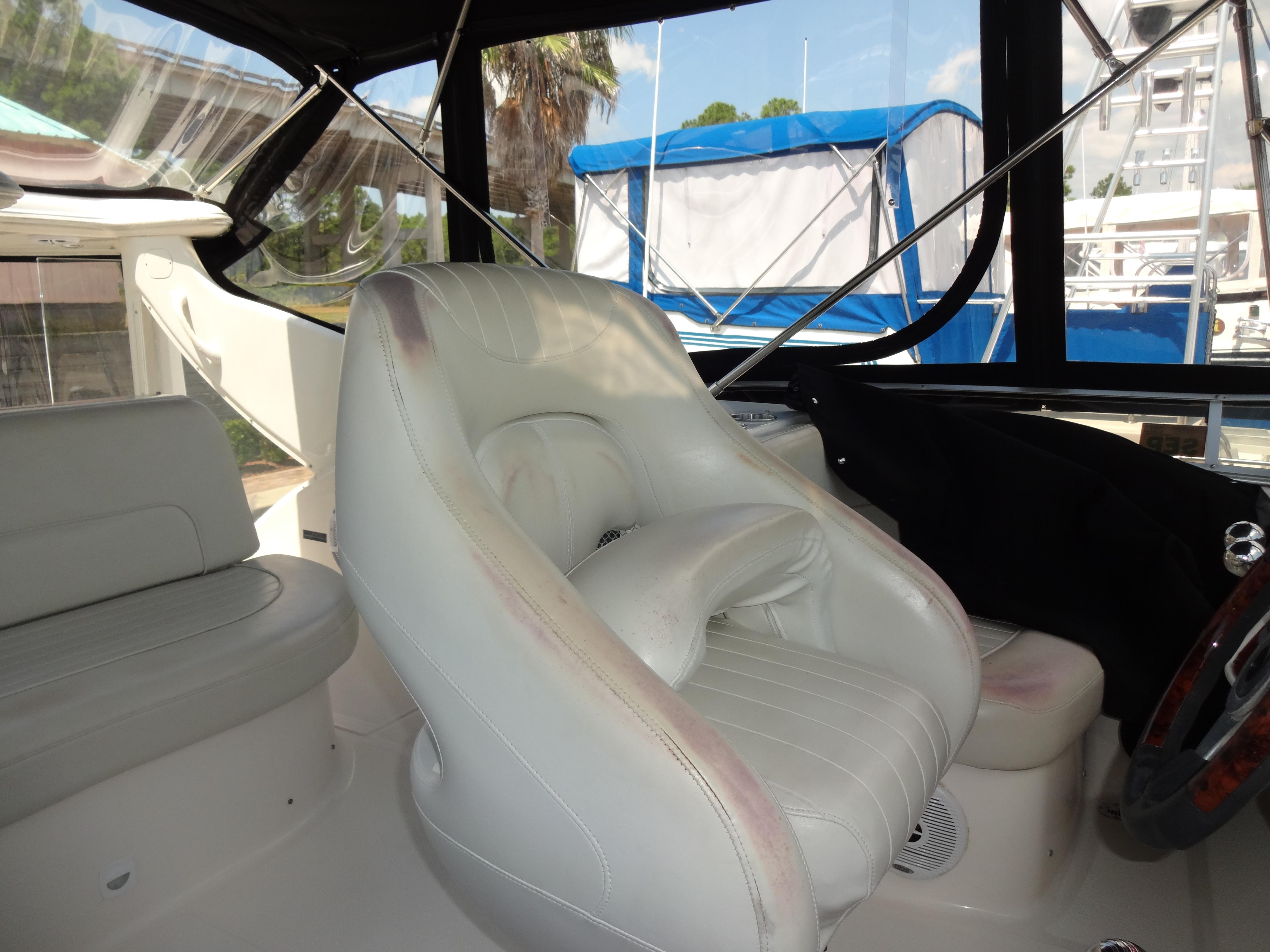 Slide: The Image of 2004 Meridian 408 Motoryacht cockpit with white leather seating and steering wheel. - 27