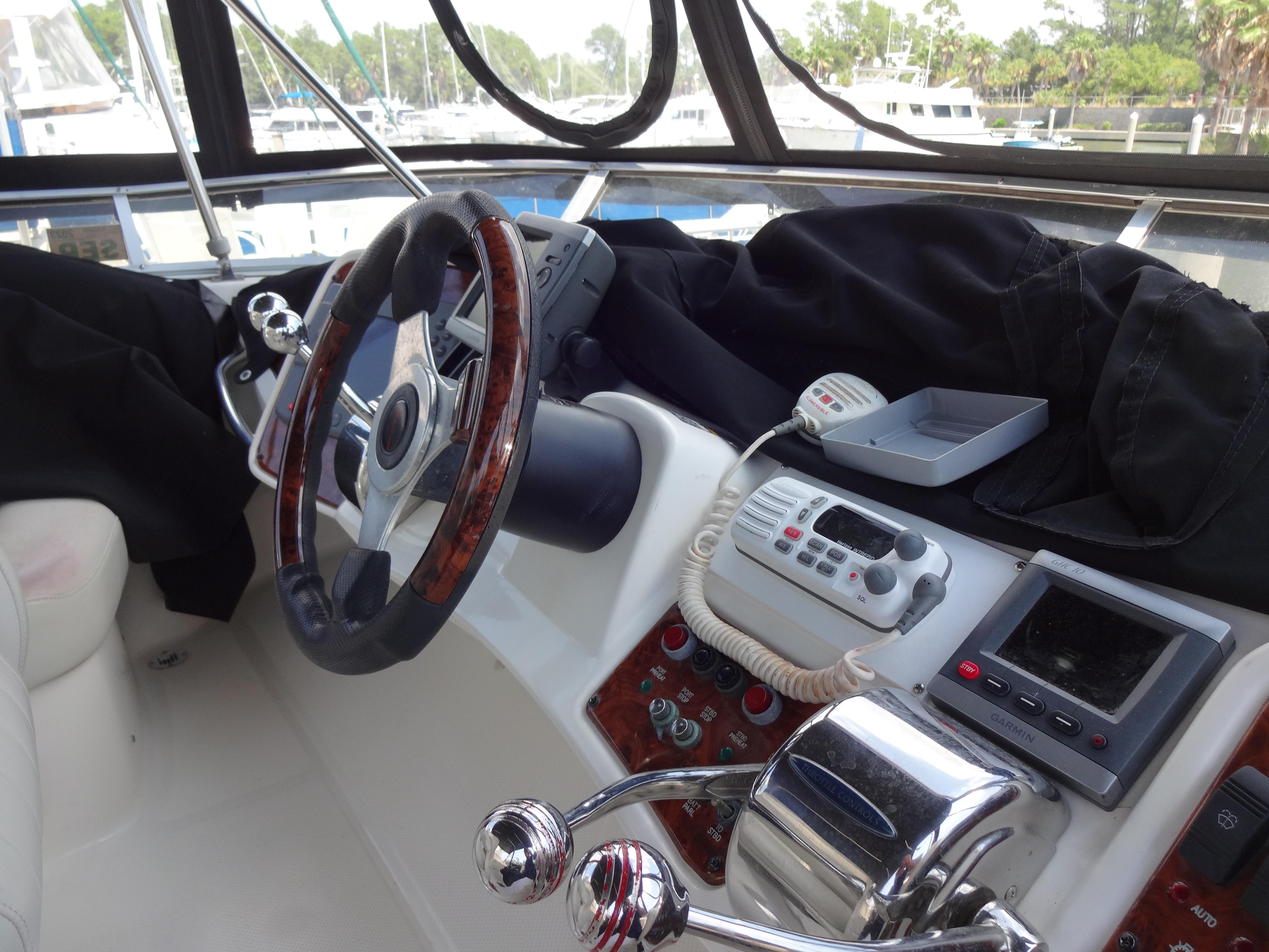 Slide: The Image of 2004 Meridian 408 Motoryacht helm with steering wheel, navigation equipment, and controls. - 28