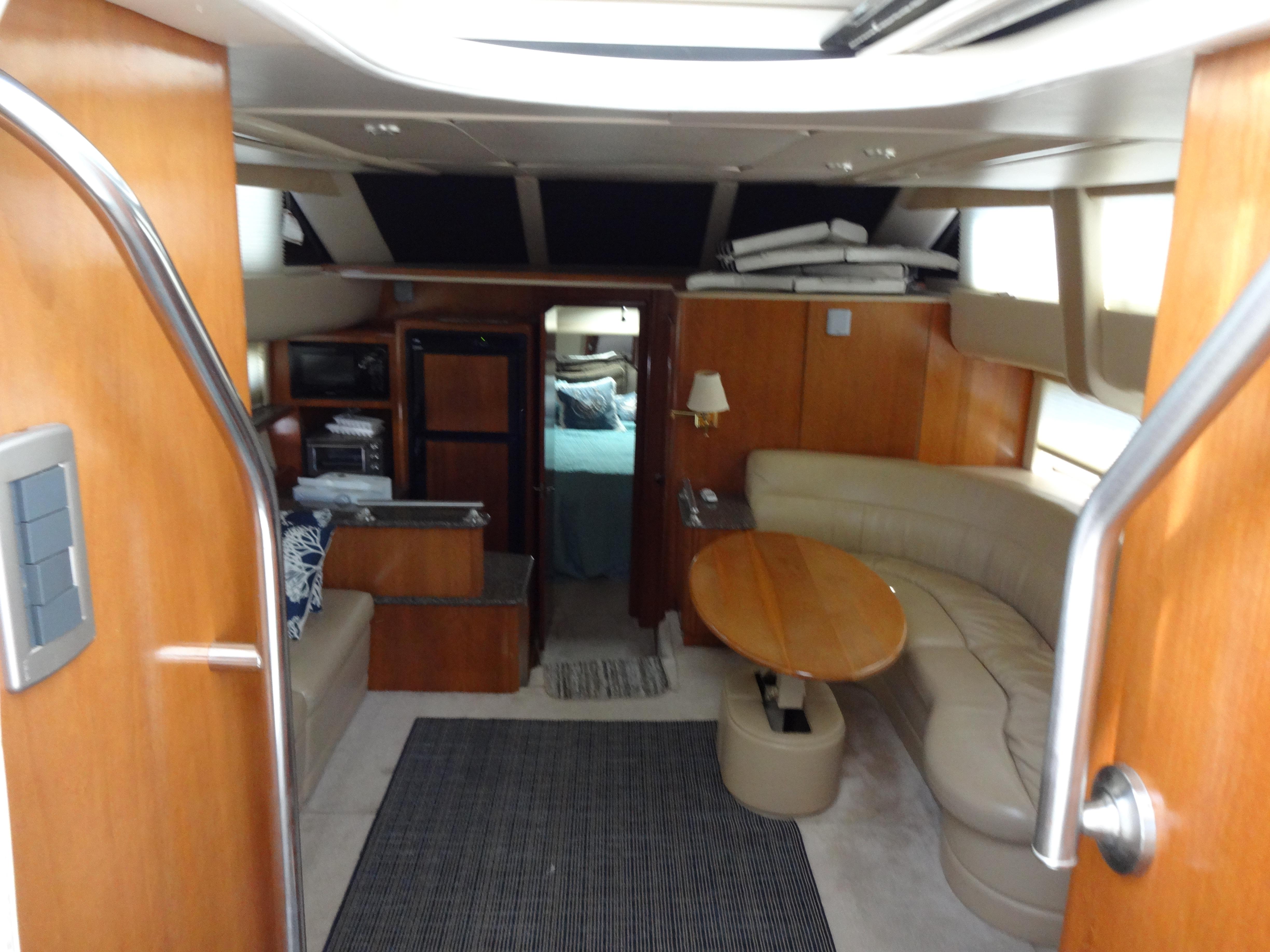 Slide: The Image of Interior of a 2004 Meridian 408 Motoryacht with wood finishes and beige seating. - 29