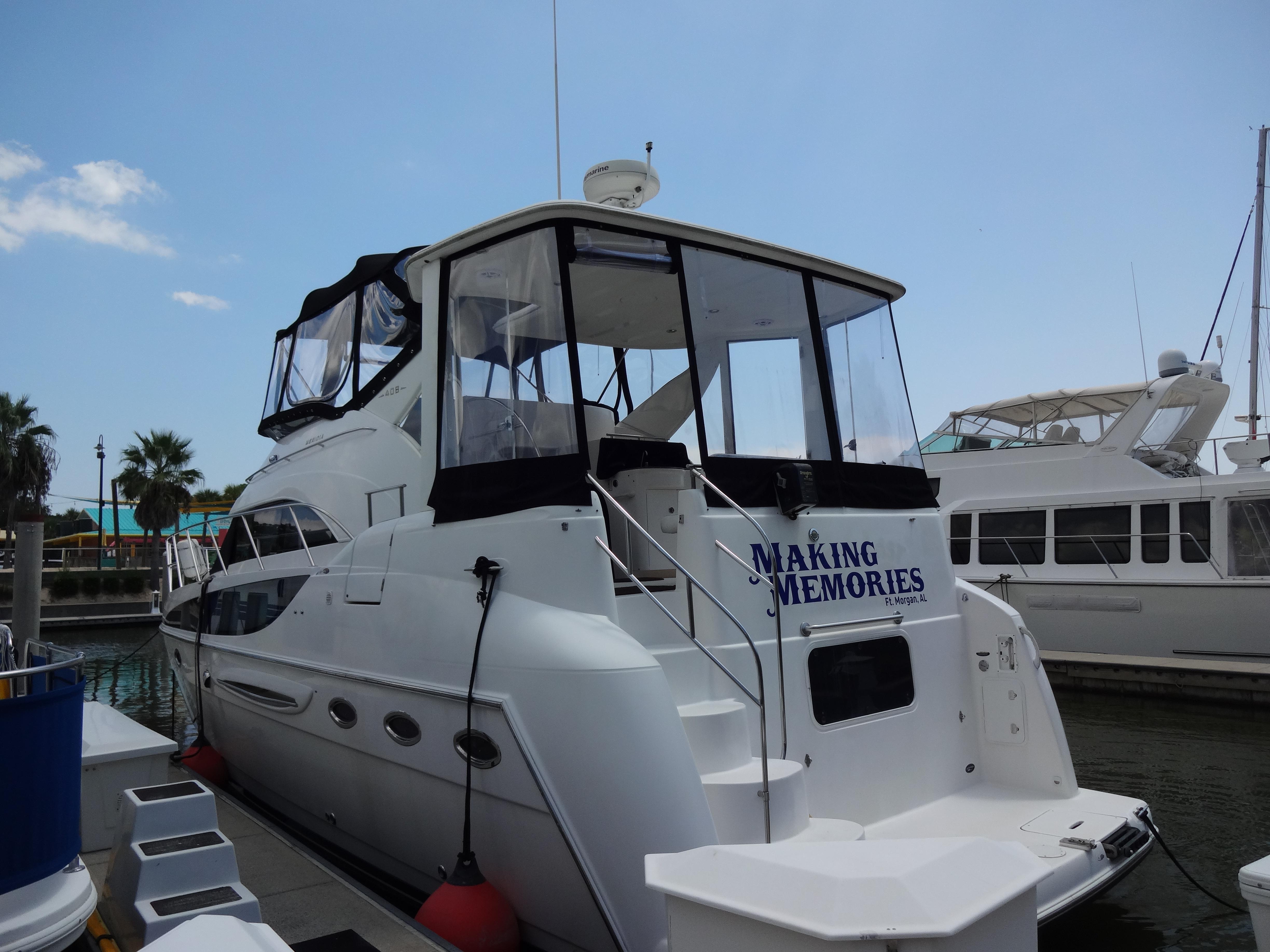 Slide: The Image of 2004 Meridian 408 Motoryacht docked, named Making Memories, with clear skies and nearby boats. - 3
