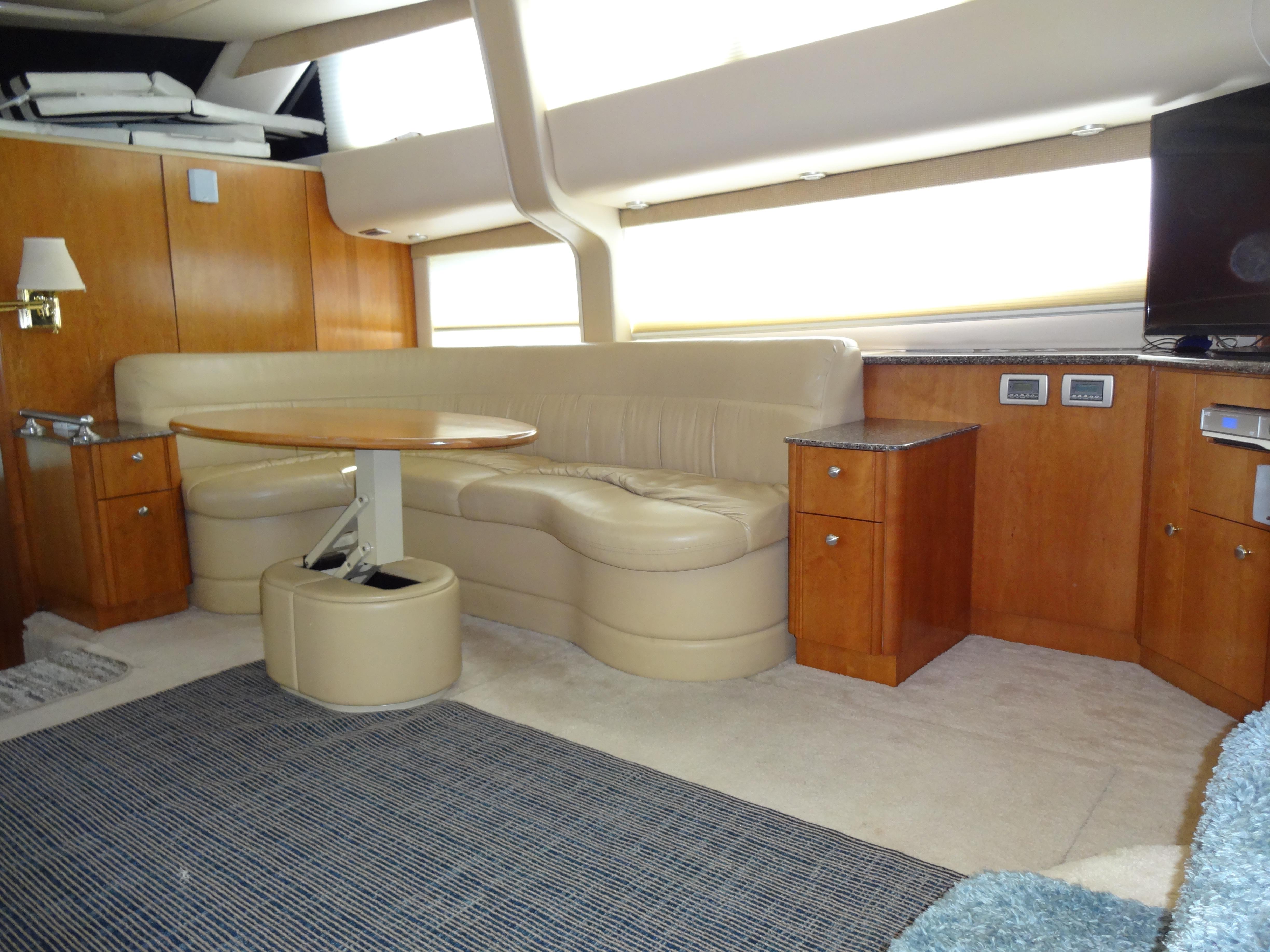 Slide: The Image of 2004 Meridian 408 Motoryacht interior with beige leather seating and wooden cabinetry. - 32