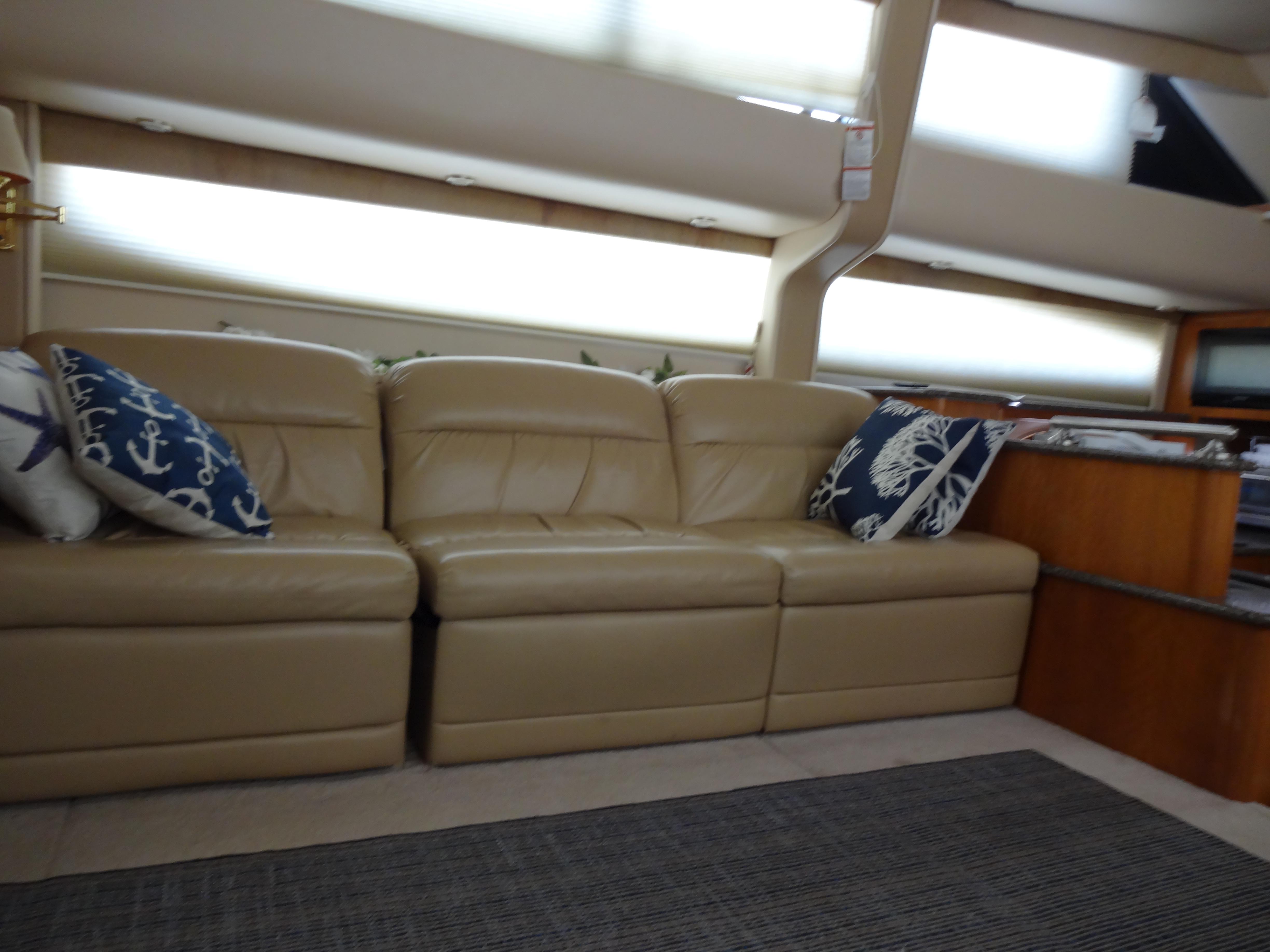 Slide: The Image of Interior of 2004 Meridian 408 Motoryacht with beige leather sofa and nautical-themed pillows. - 33