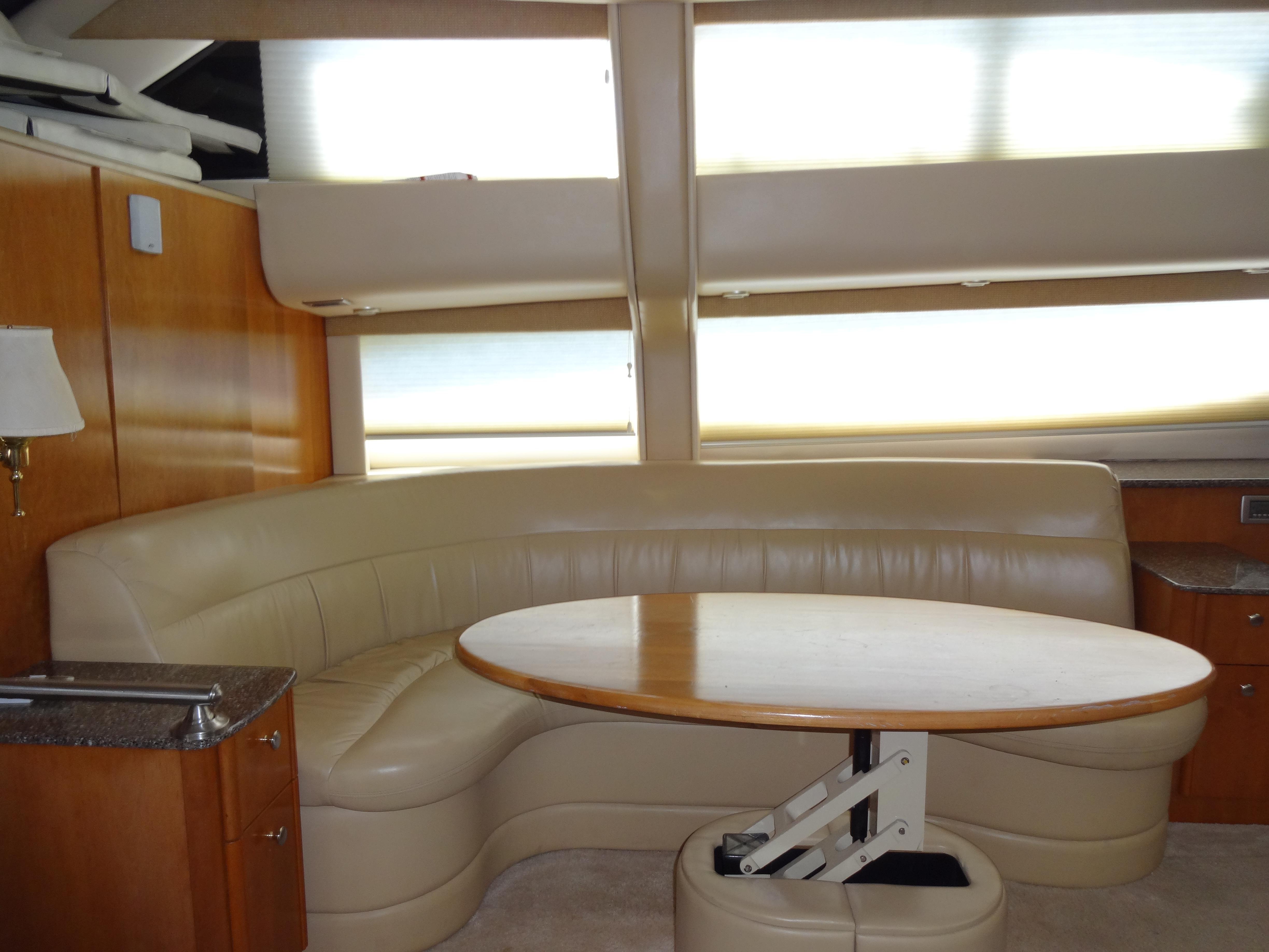 Slide: The Image of Interior of 2004 Meridian 408 Motoryacht with leather seating and wooden table. - 34